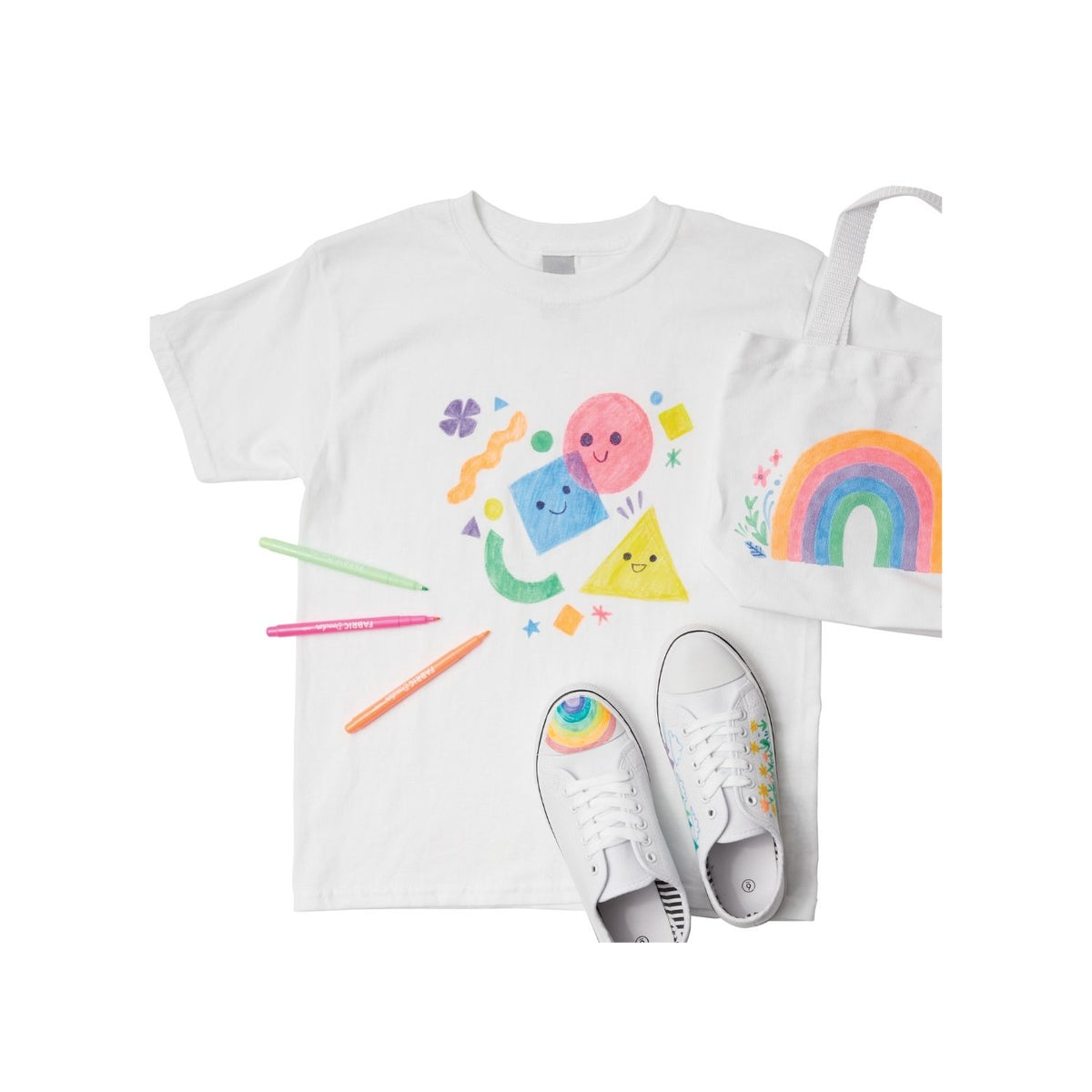 White t-shirt with colorful designs and white sneakers on a white background
