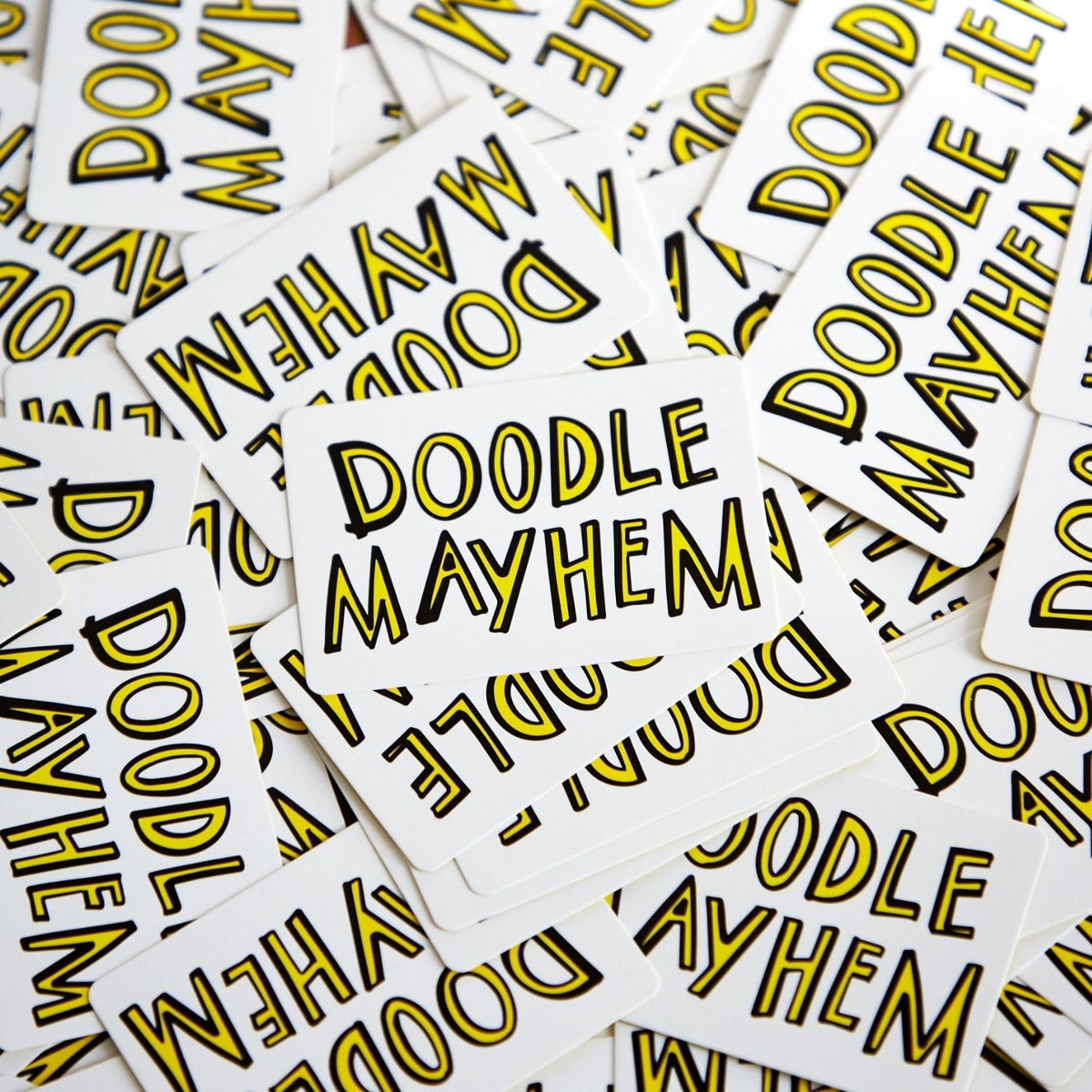 Cards with 'Doodle Mayhem' text in yellow on a white background