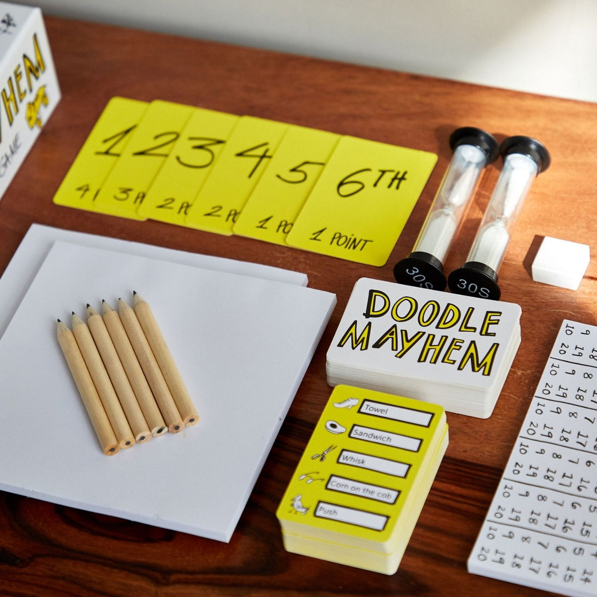 A top-down view of the open box showing all pencils, pads, and cards fitting neatly back into their designated storage slots.