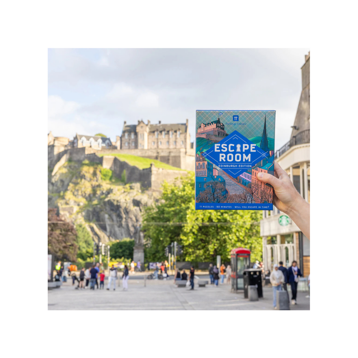 Book titled &#39;Escape Room Edinburgh&#39; held up with a cityscape in the background