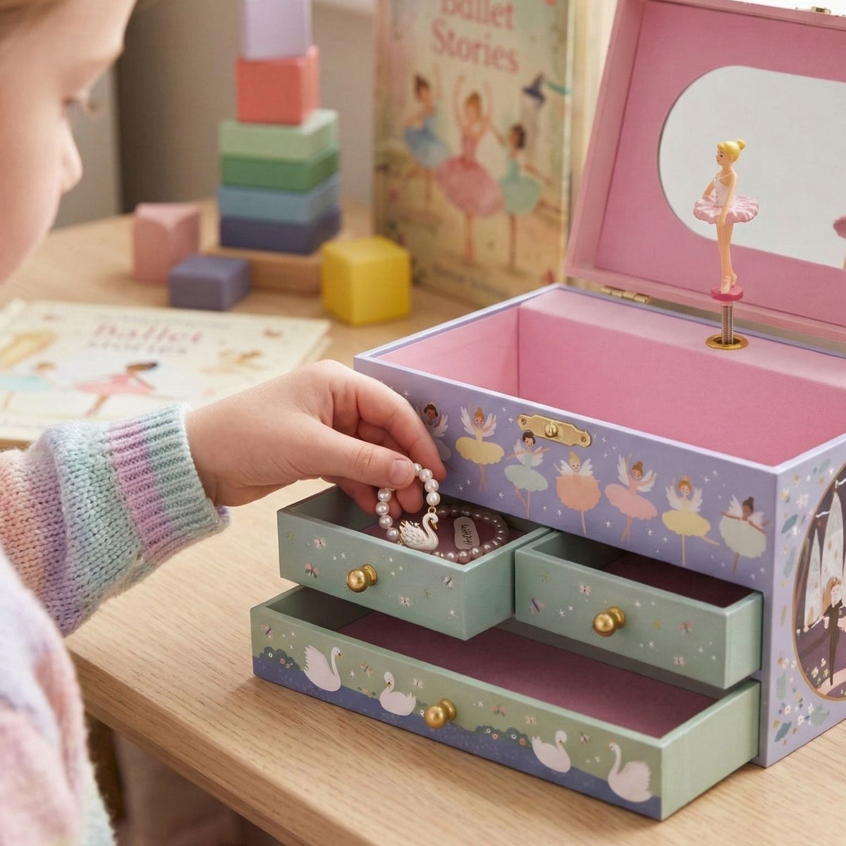 The ballerina jewellery box sitting on a bedside table, highlighting its dimensions and how it complements a child’s bedroom decor.