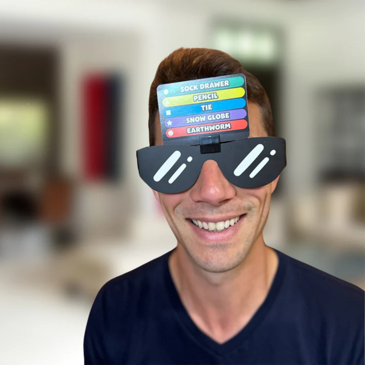 A close-up of the stylish black "Guesser" shades, designed to keep the player in the dark while the rest of the group races to draw.