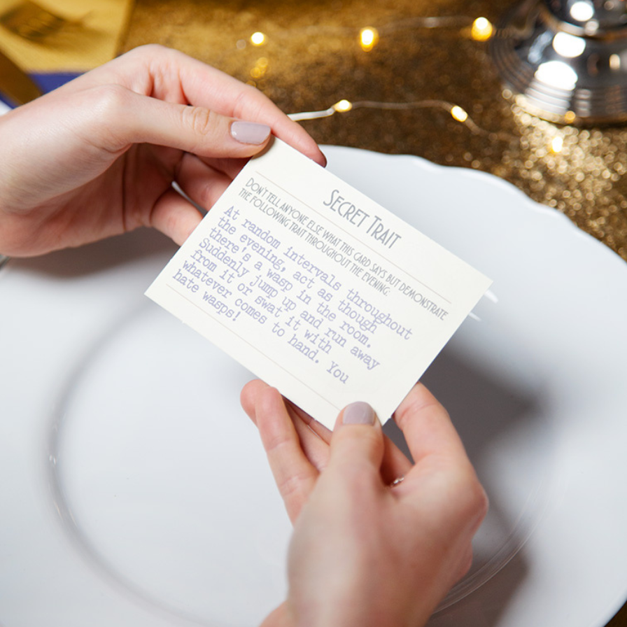 Person holding a card with text on it against a blurred background