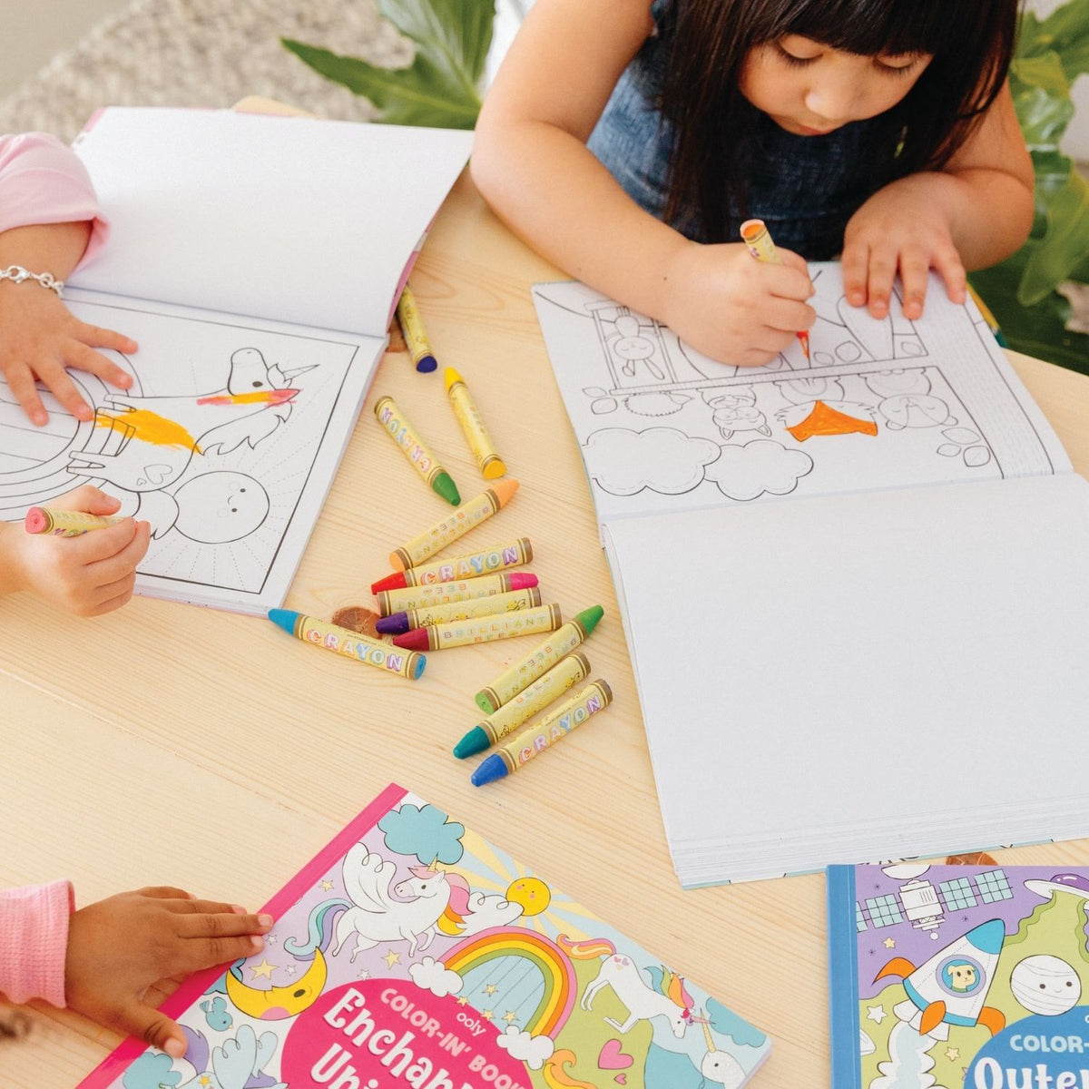 A young child sitting at a table colouring a detailed starry-eyed unicorn, showing the book's role in encouraging calm, screen-free time.