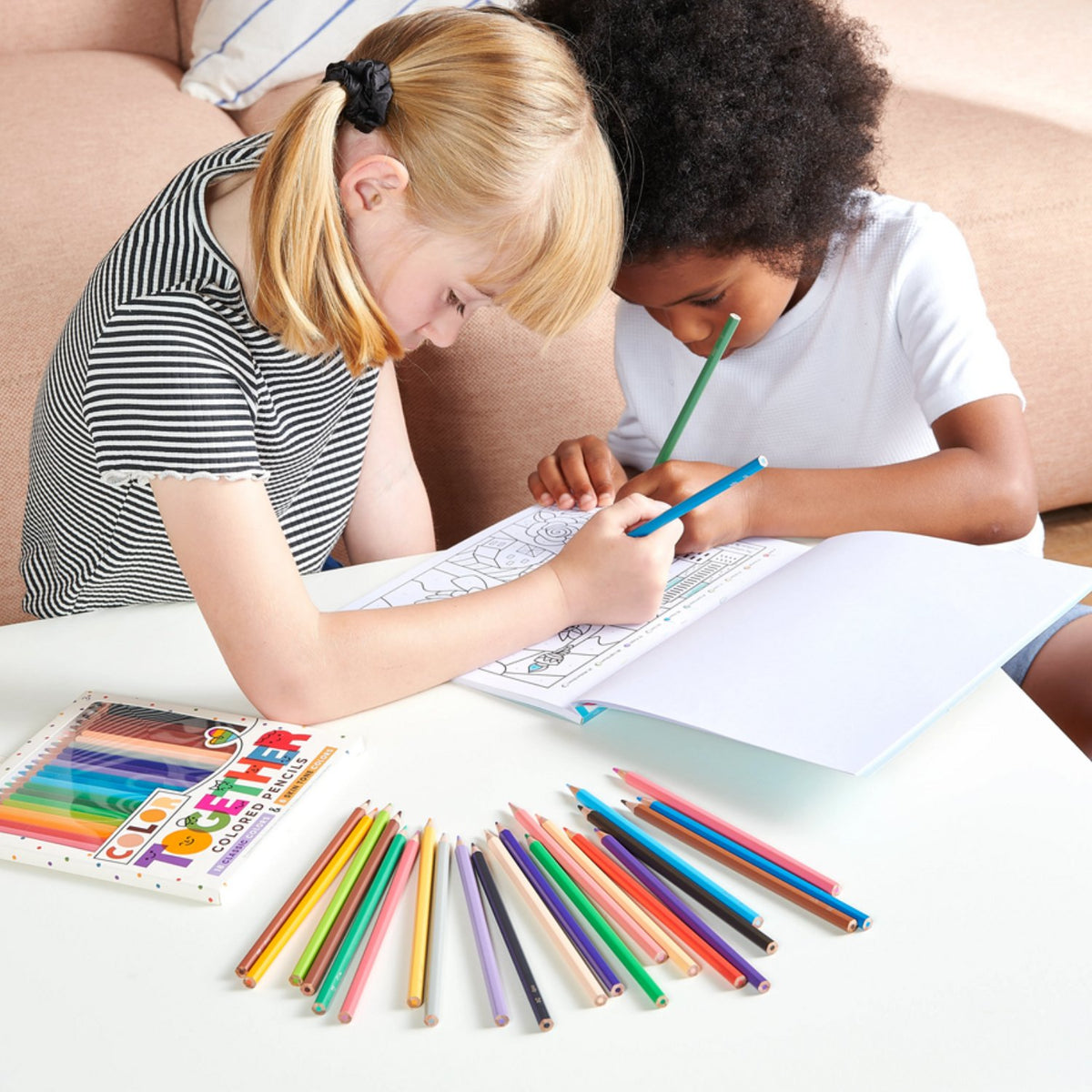 Two children sharing the 24-pack to draw a group of friends, demonstrating how the set fosters social interaction and empathy.