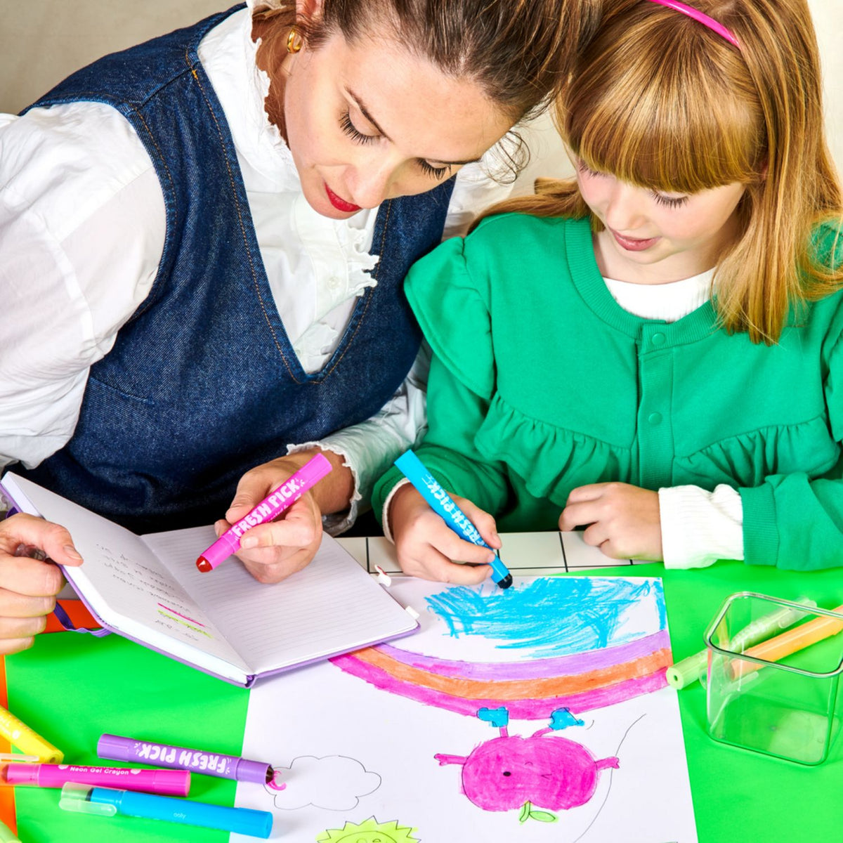 A child using the twist-up crayon to colour, showing how the plastic barrel protects fingers from the gel ink for mess-free creativity.