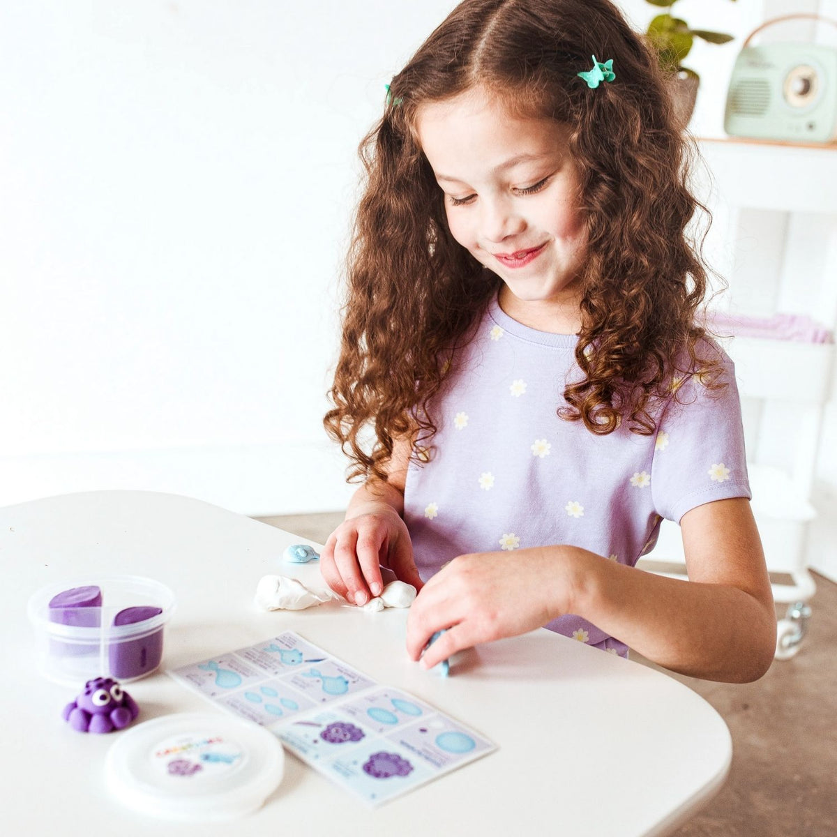 A young creator following the instruction sheet to form the whale’s tail, highlighting the kit’s role in building confidence and focus.