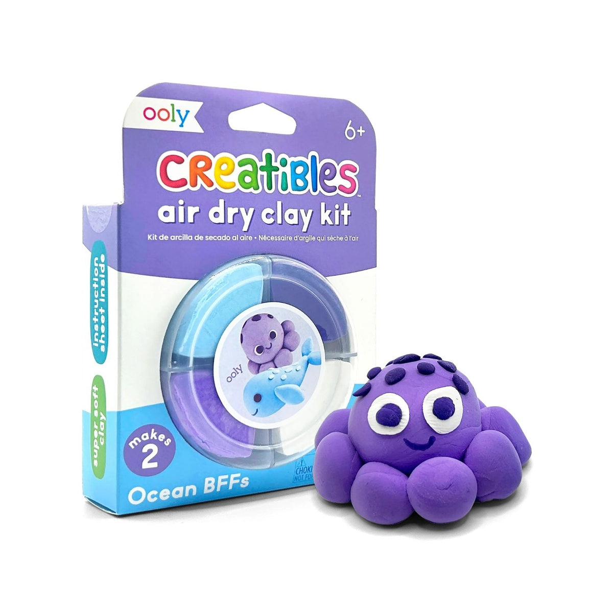Purple octopus clay creation next to its packaging, which is labeled 'Oolly Creatibles air dry clay kit'.